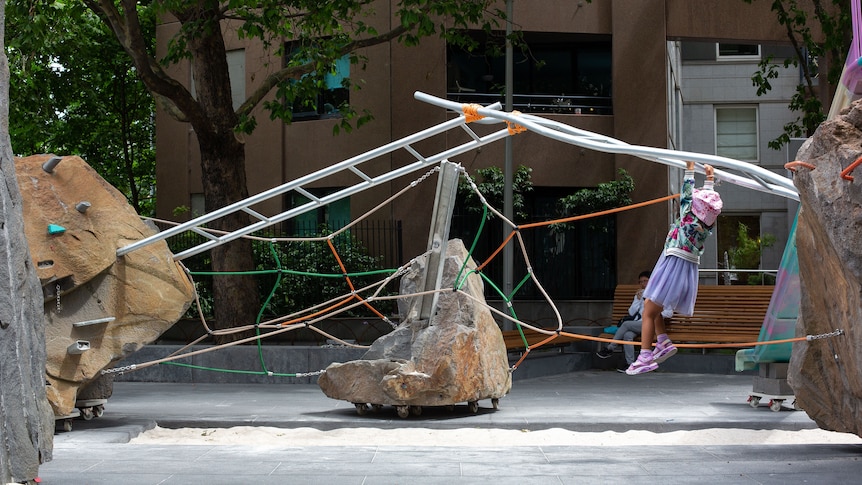 A small child playing on the monkeybars at the Southbank park