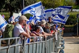 A group of people holding Israeli flags.