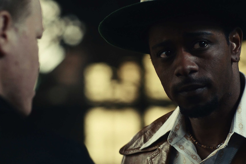 Actor Lakeith Stanfield speaking to Jesse Plemons in film Judas and the Black Messiah