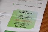 Close up of power bill showing $6,000 debt.