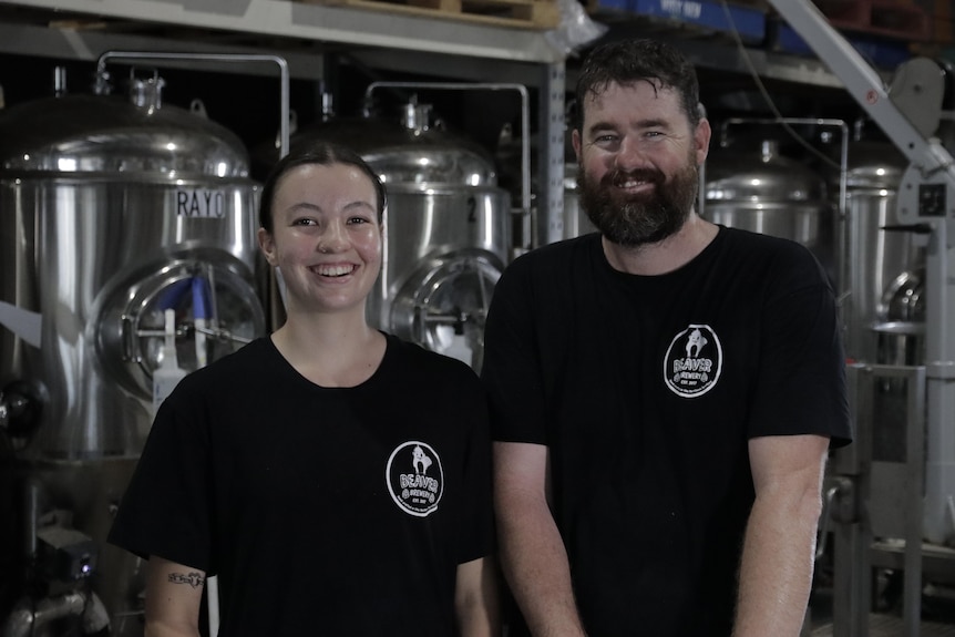 Nayana Patmore and Chris Brown smiling inside a brewery.