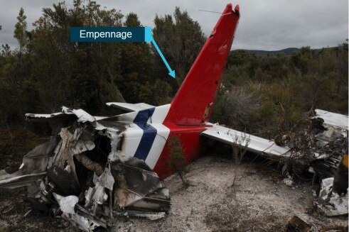 Wreckage from a light plane crash, showing the plane's tail and burnt wreckage