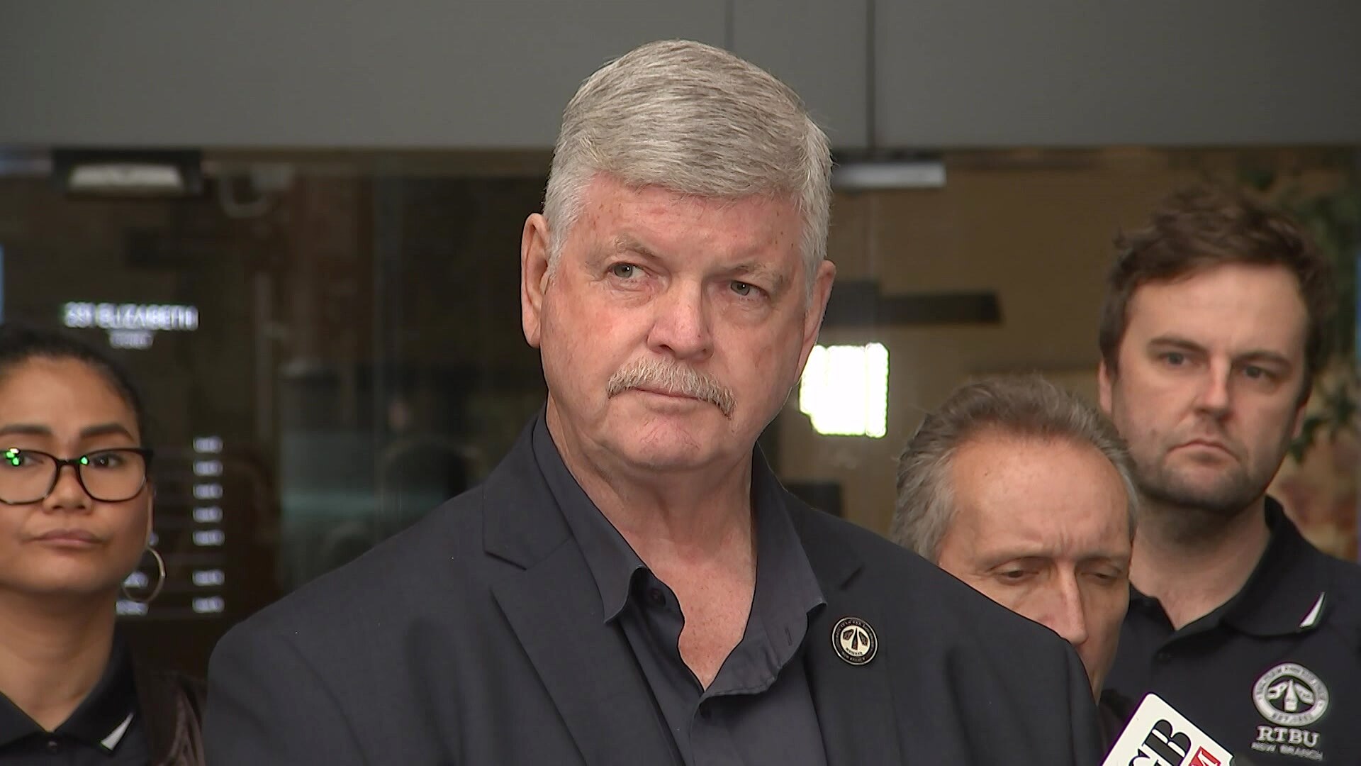 a man with a mustache looking sideways