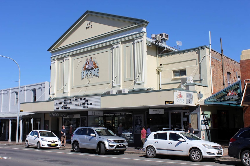 A historic building on a country street beneath a blue sky.