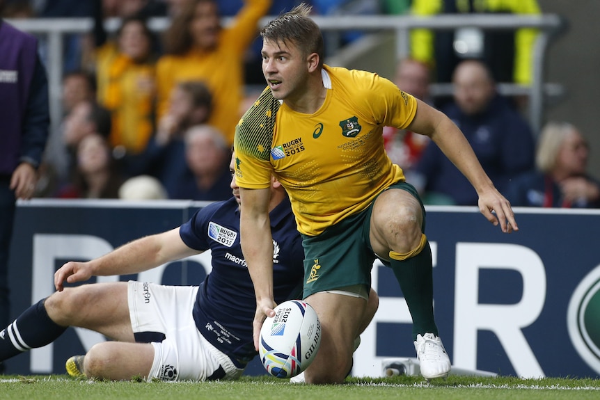 A Wallabies player on one knee after scoring a try against Scotland at the 2015 Rugby World Cup.