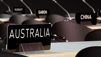 A nameplate with 'Australia' on it sits in the main (and empty) plenary hall at the Bella Centre during the UN Climate Change...
