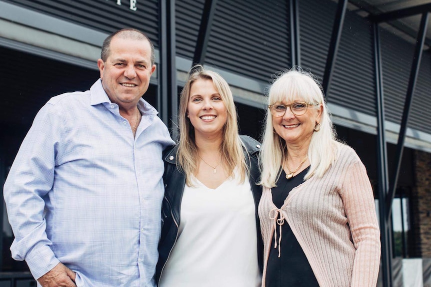 Man and two women standing together