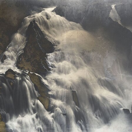 A black and white photo of a large series of waterfalls overlaid with infra-red images from the same location
