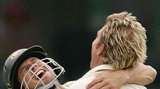 Shane Warne hugs Brad Hodge who also contributed in the field