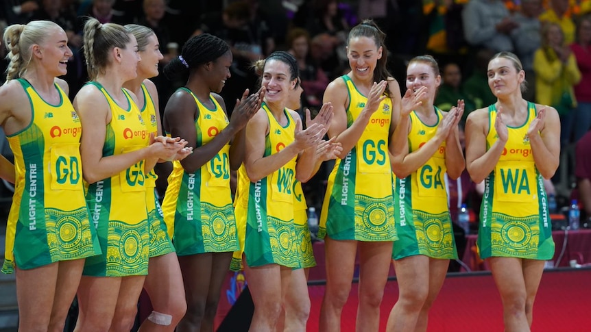 Australian players clap their hands after defeating Zimbabwe in their opening game at the Netball World Cup.