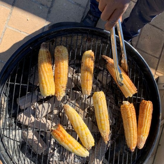 Freshly-picked maize cooked over hot coals