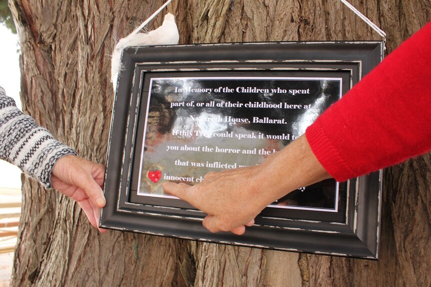 Close up of a home made plaque in Ballarat nailed to a tree outside the Nazareth House.