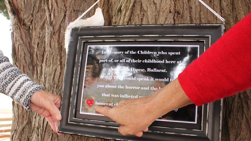 Close up of a home made plaque in Ballarat nailed to a tree outside the Nazareth House.