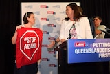 An anti-coal mining protester with Premier Annastacia Palaszczuk