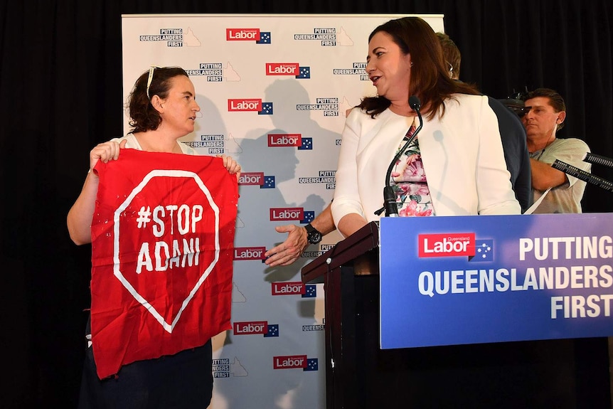 An anti-coal mining protester with Premier Annastacia Palaszczuk