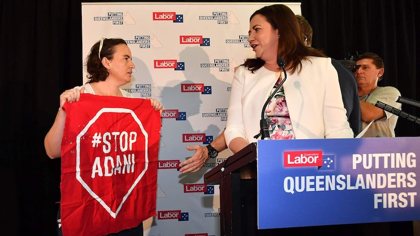 An anti-coal mining protester with Premier Annastacia Palaszczuk