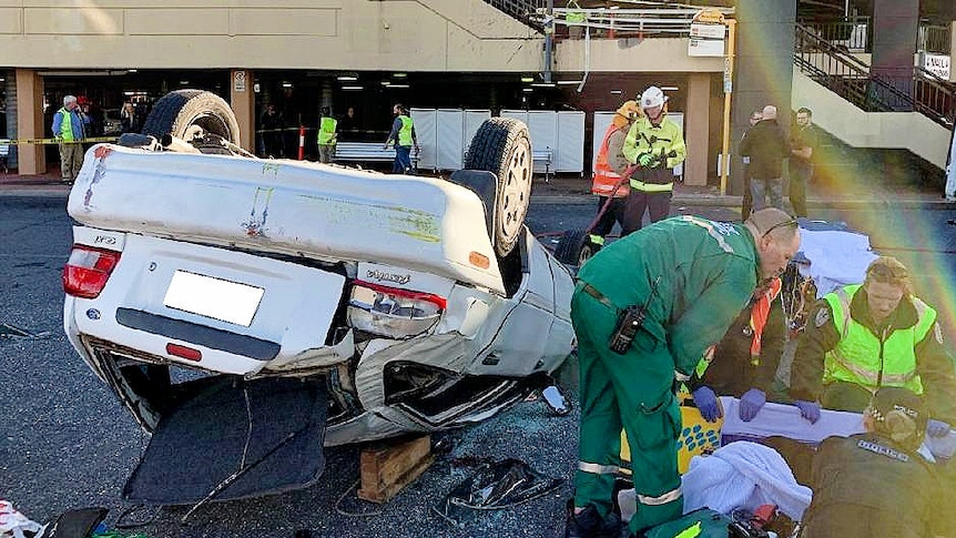 A Ford Festiva crashes through the barrier of a first floor car park at Westfield Marion in Adelaide