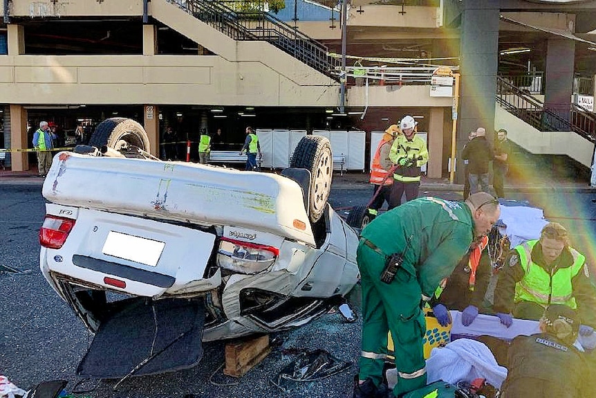 A Ford Festiva crashes through the barrier of a first floor car park at Westfield Marion in Adelaide