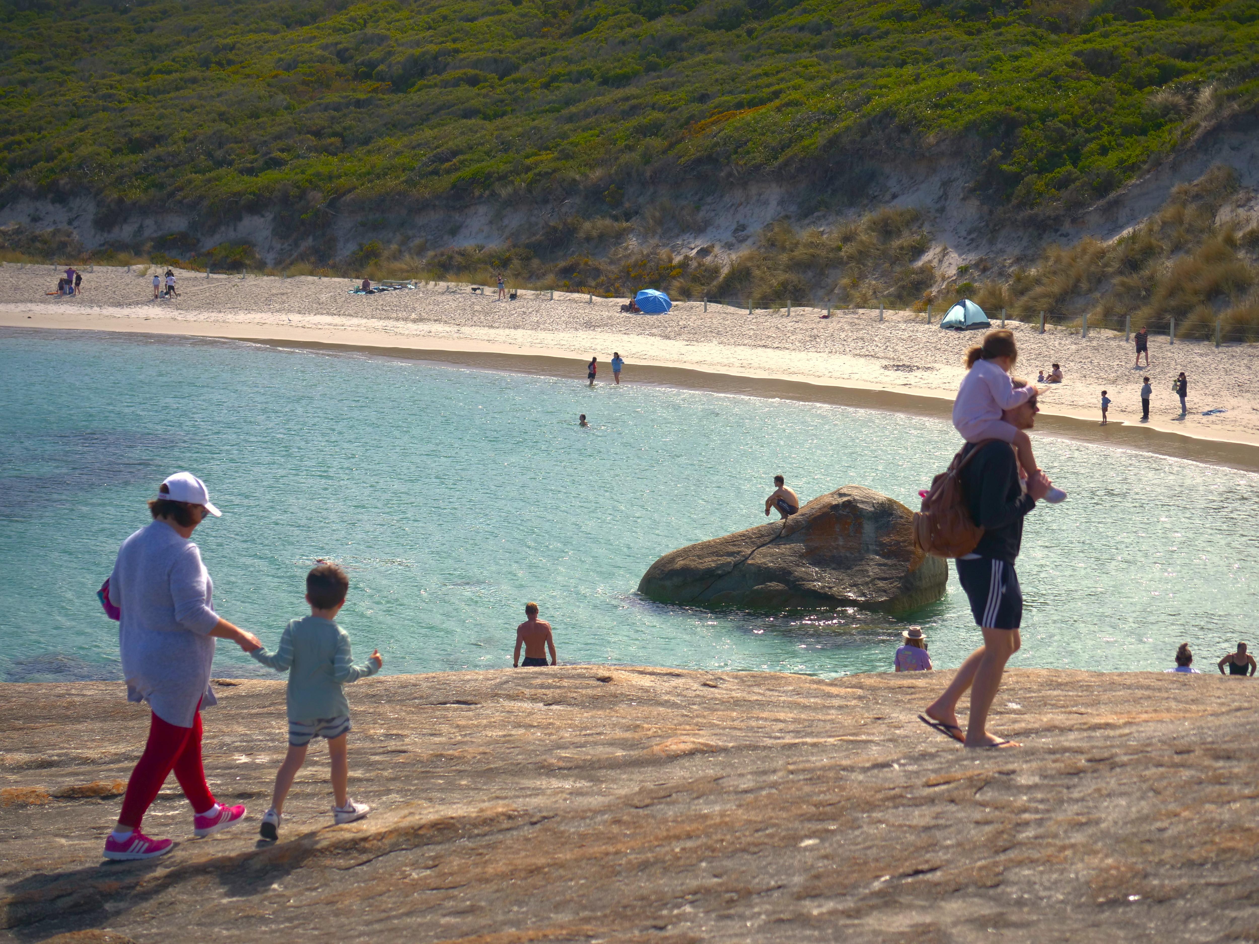 People enjoy fine weather at a pristine beach.