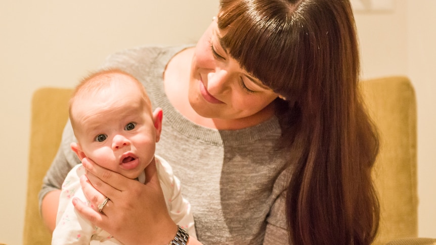 Jess Harden with her baby who suffered from a food allergy in a story about what to do before changing a kid's diet.