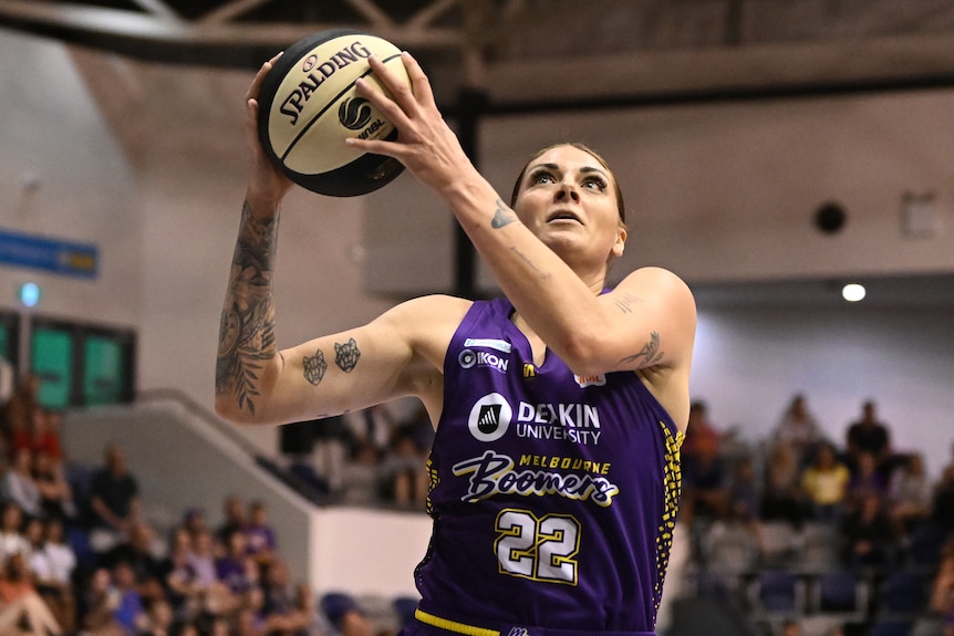 Cayla George drives at the basket during a WNBL game