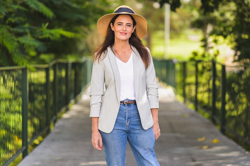 Ali France, Labor candidate for Dickson stands outside in a park in Brisbane.