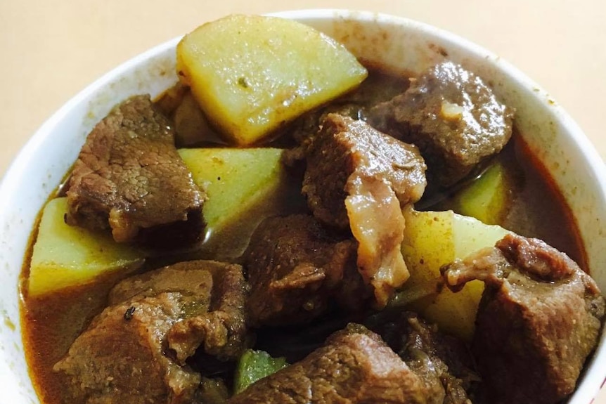A bowl of curry including cooked kangaroo meat, potatoes and stew
