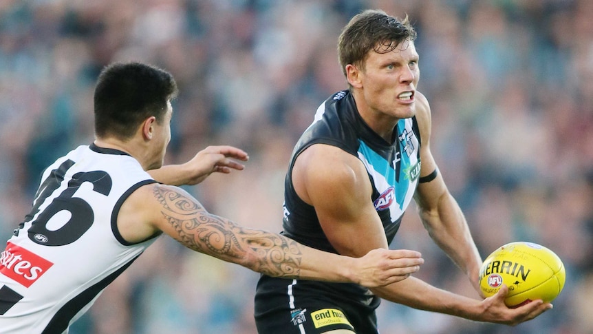 Ebert handballs against Magpies