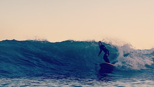 A surfer rides a wave.