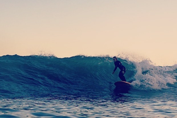 A surfer rides a wave.