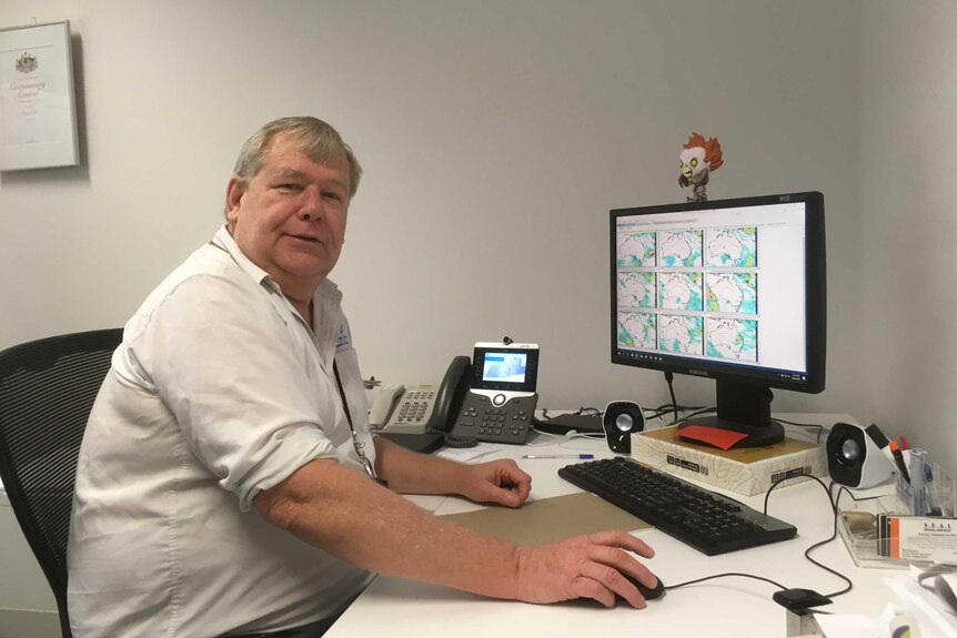 Bureau of Meteorology forecaster Roger Lurz sitting at a computer at East Sale RAAF Base