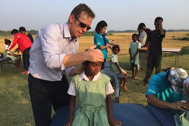 Mike Brett treating schoolchildren