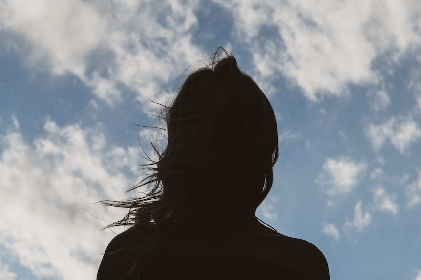 A silhouette of an anonymous woman