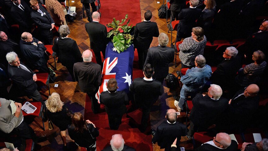 The casket of former NSW Premier Neville Wran is carried into Town Hall for his State Funeral in Sydney, May 1, 2014