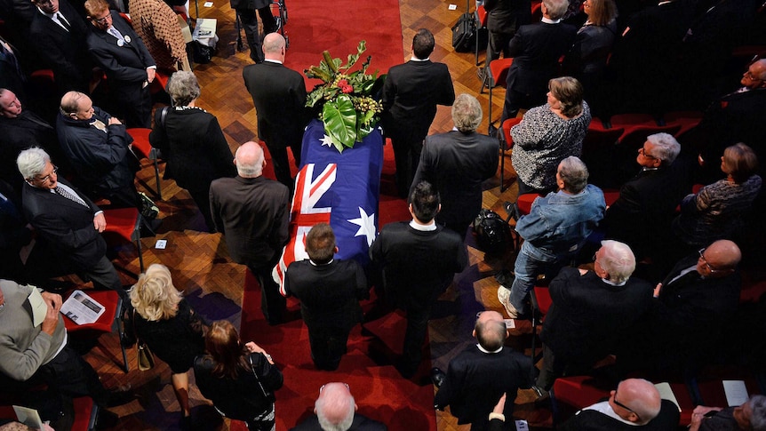 The casket of former NSW Premier Neville Wran is carried into Town Hall for his State Funeral in Sydney, May 1, 2014