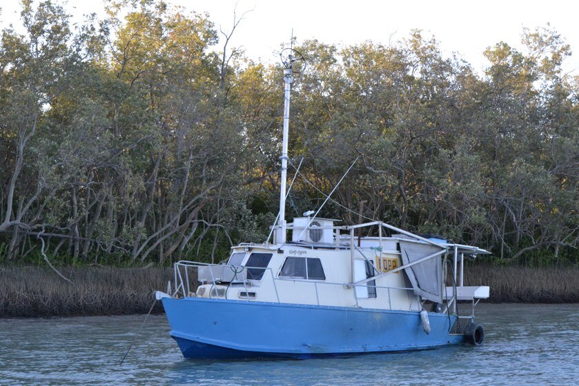 A fishing boat anchored to the Norman River
