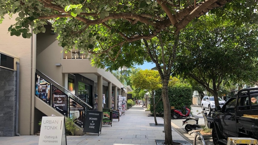 A street with shop signs out the front, but no people.