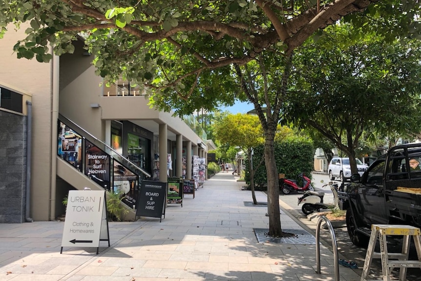 A street with shop signs out the front, but no people.