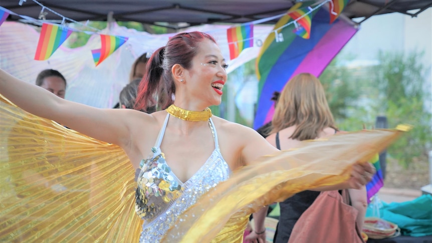 A woman twirls in a sparkly outfit