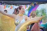 A woman twirls in a sparkly outfit