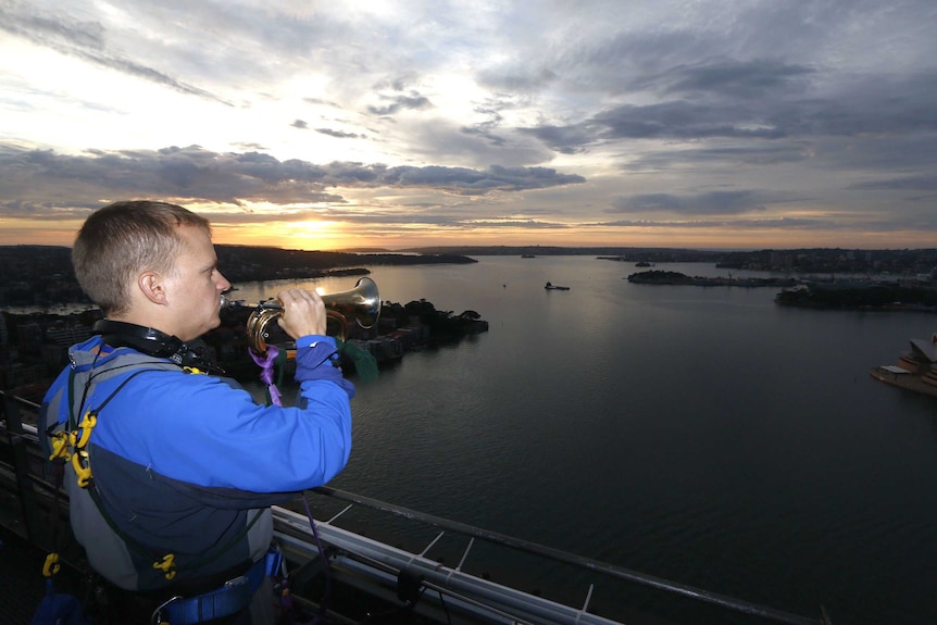 Man playing the bugle overlooking Sydney Harbour.