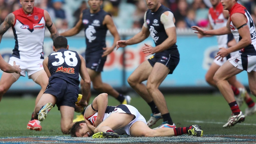 Melbourne co-captain Jack Grimes is hurt against Carlton at the MCG.