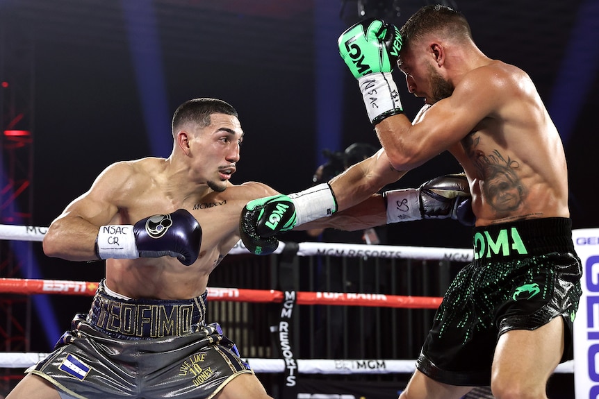 Teofimo Lopez Jr punches Vasiliy Lomachenko in the stomach