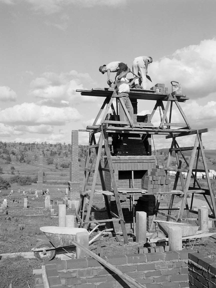 Building a chimney on a house in Cooma, NSW, 1950.