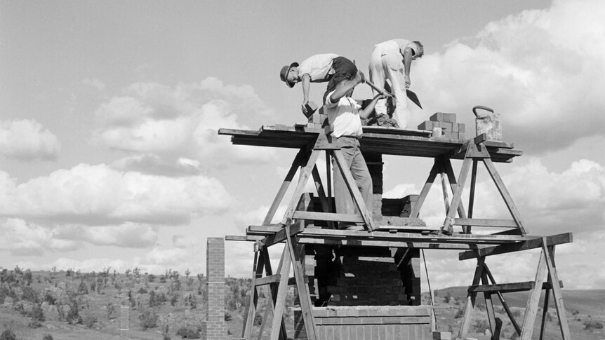 Building a chimney on a house in Cooma, NSW, 1950.