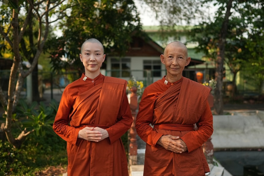 Two women in saffron monks' robes.