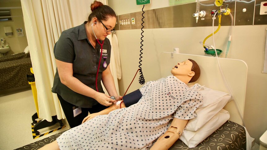 Louise Scarcella, a first year nursing student in Melbourne practises on a prop.