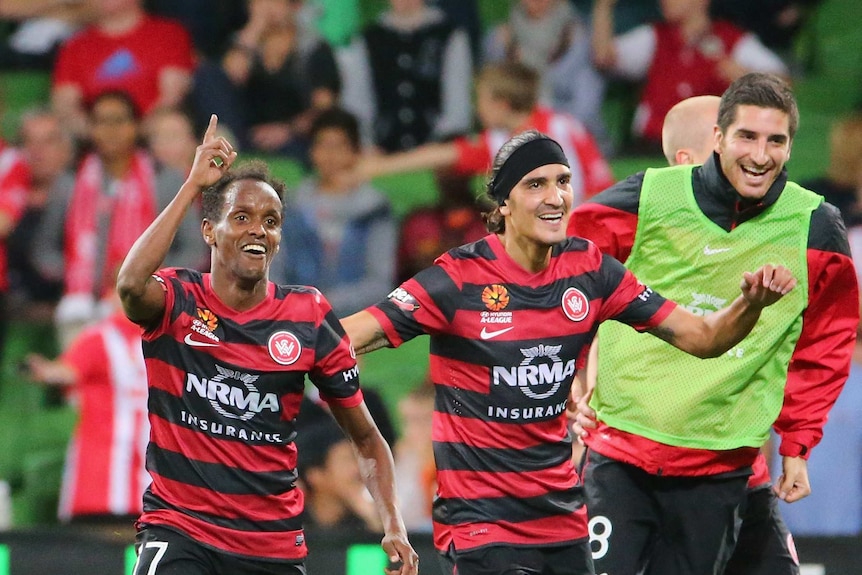 Youssouf Hersi (L) celebrates scoring a goal for the Wanderers against Melbourne Heart.