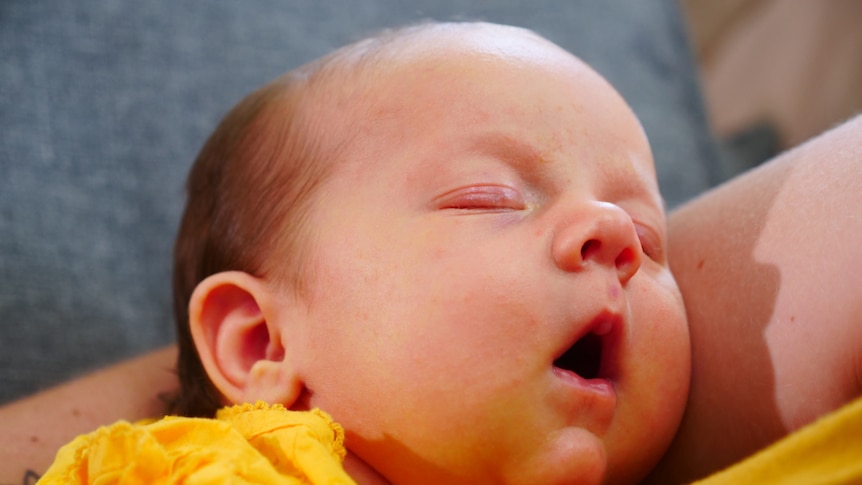 A sleeping baby with its mouth open
