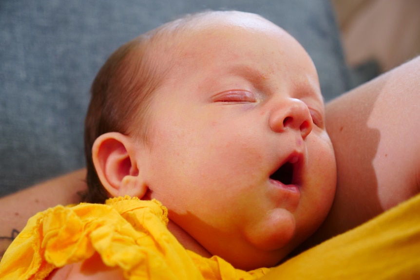 A sleeping baby with its mouth open